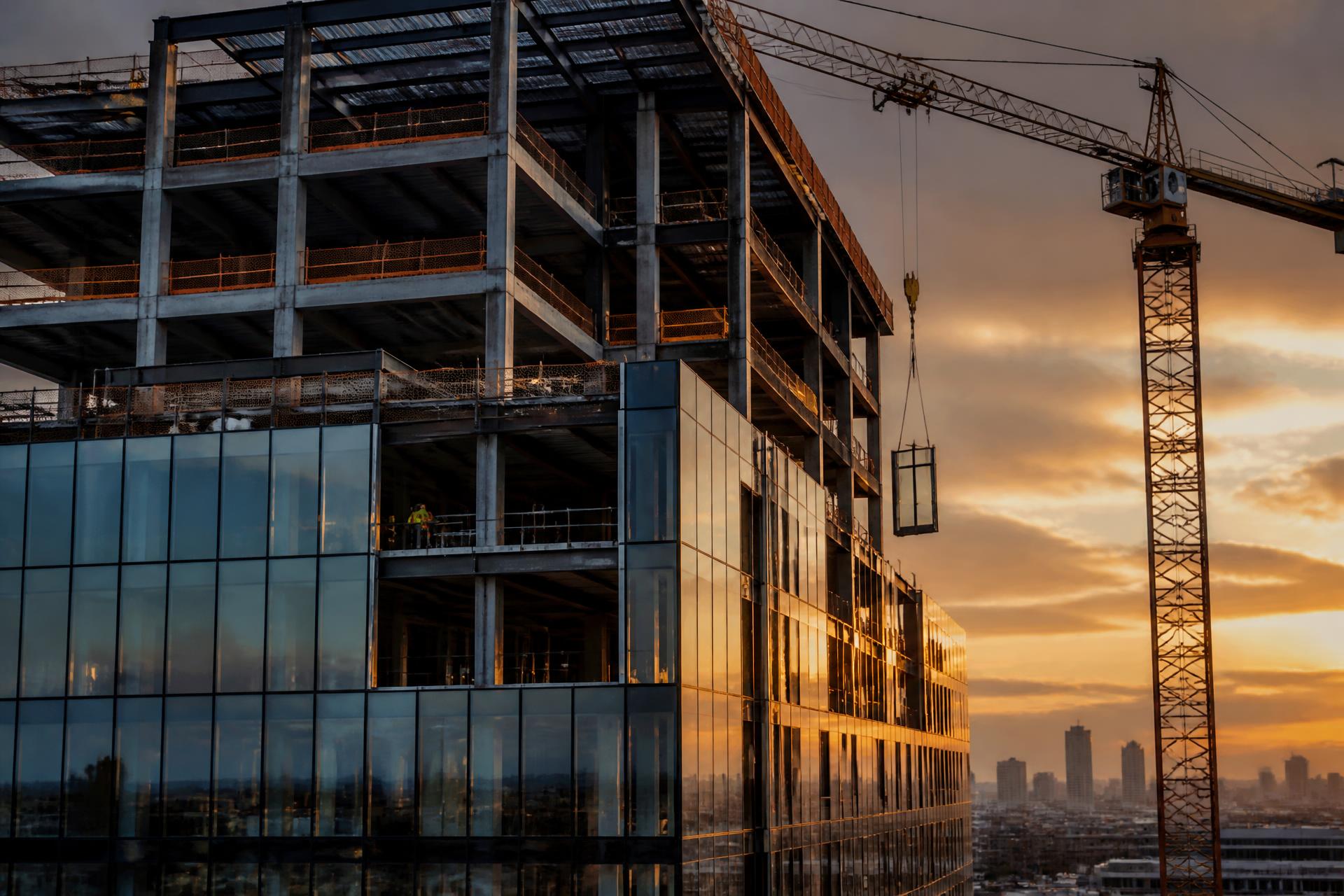 Commercial high-rise construction site at golden hour